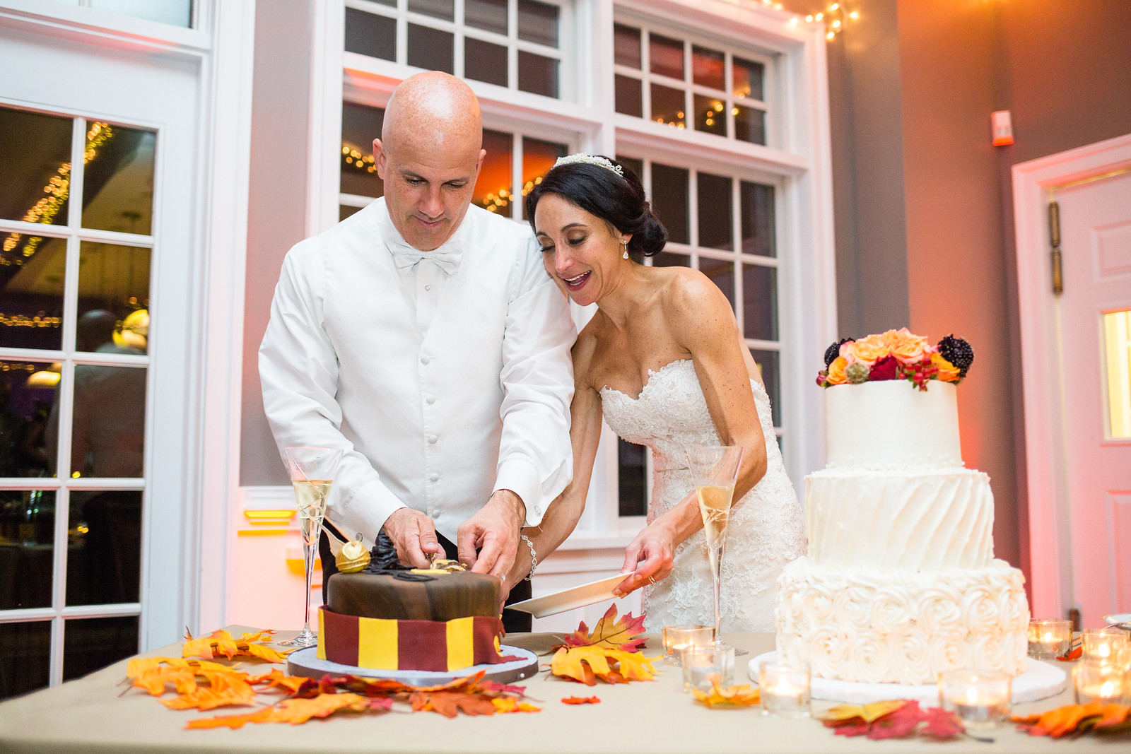 bride and groom cutting wedding cake by perfect planning events