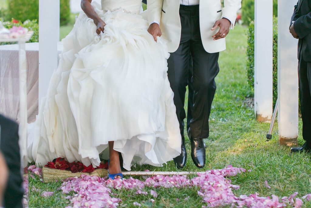 Newlyweds jumping the broom at a wedding by DC wedding planners Signature Concepts.